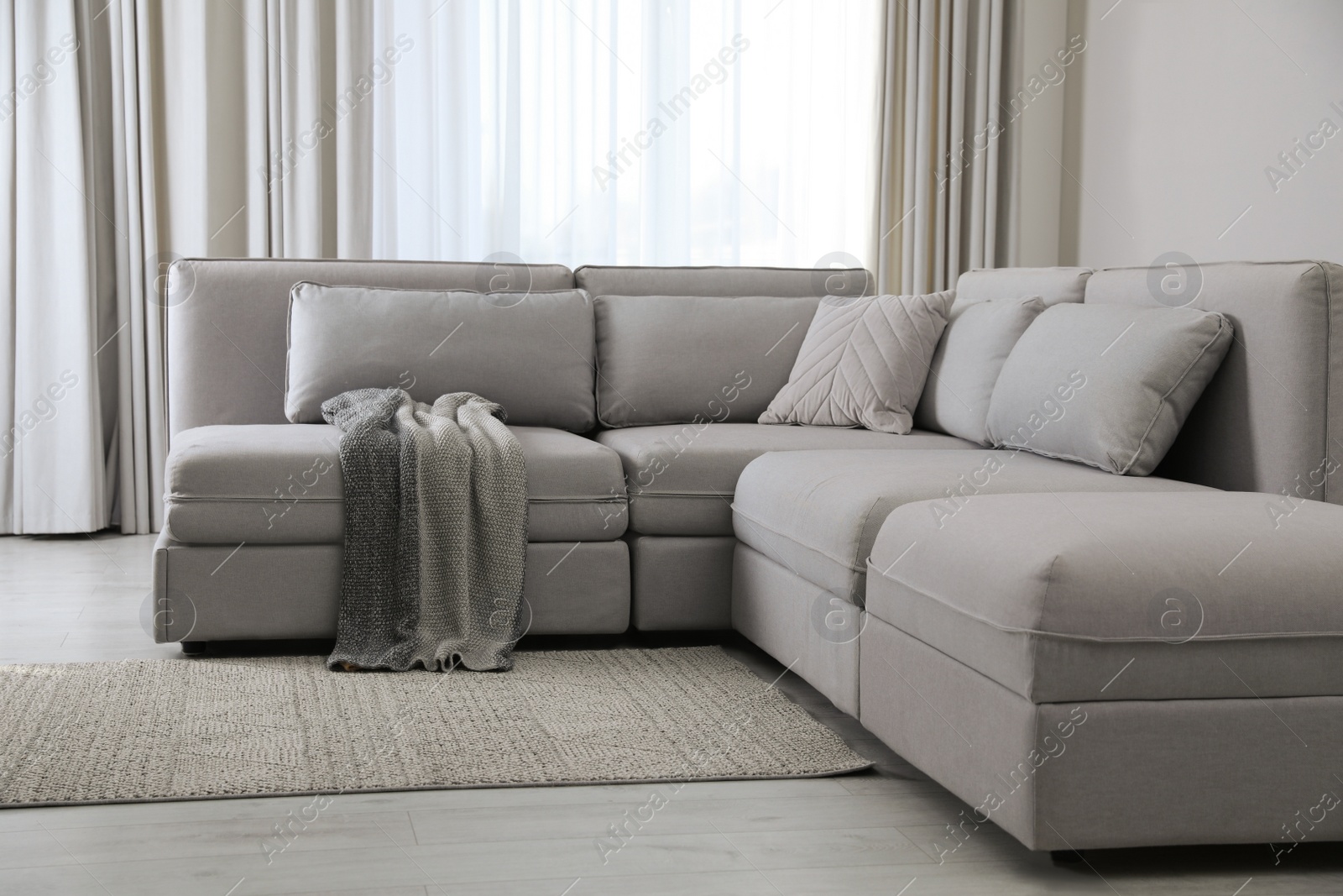 Photo of Large grey sofa in living room. Interior design