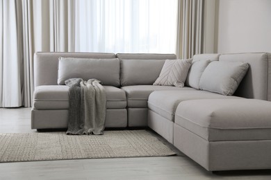 Large grey sofa in living room. Interior design