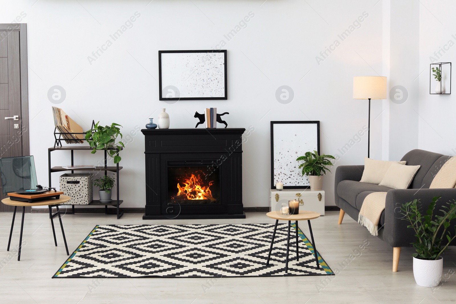 Photo of Stylish living room interior with fireplace and comfortable sofa