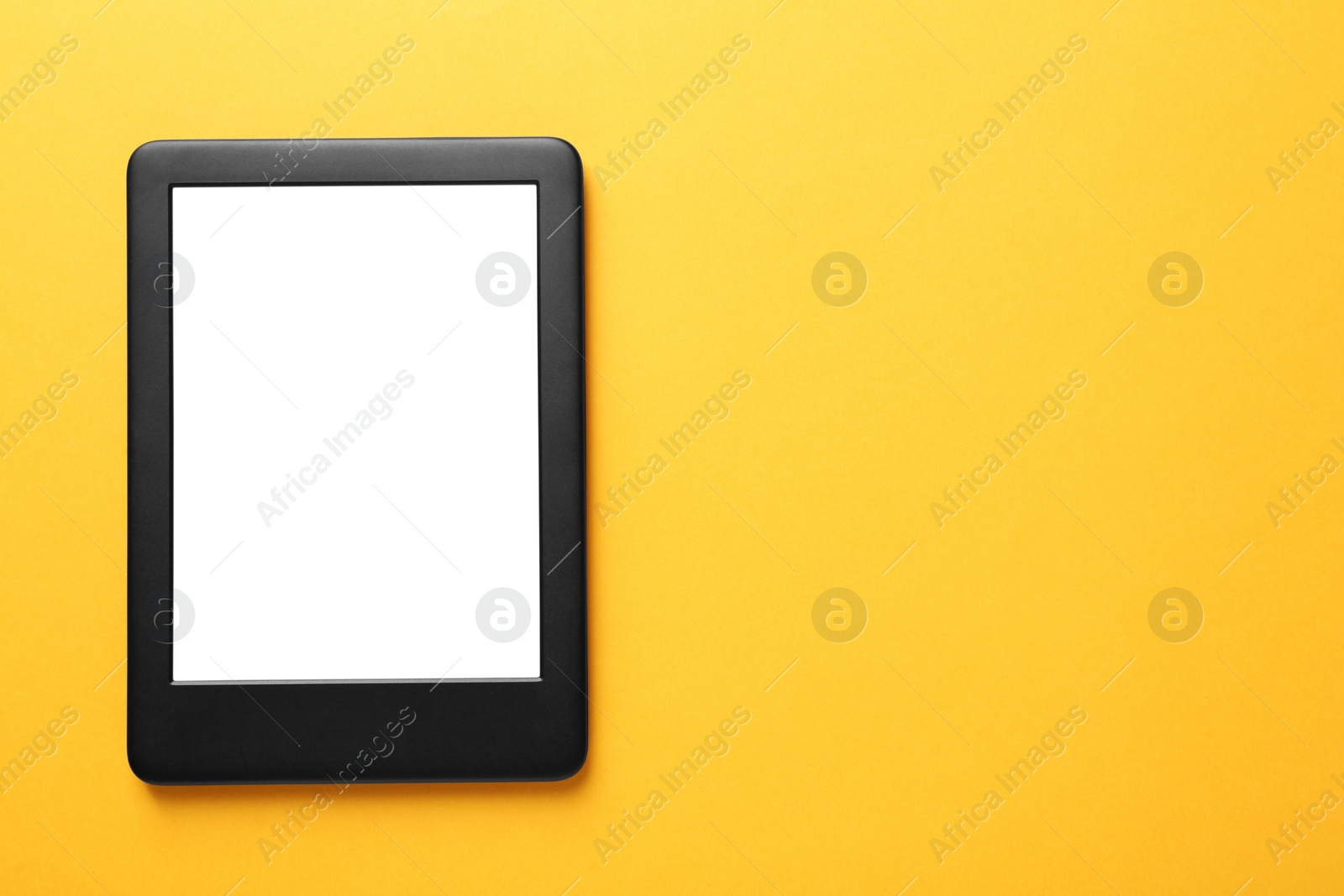 Photo of Modern e-book reader with blank screen on orange background, top view. Space for text