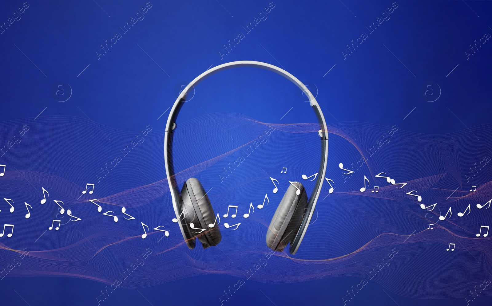 Image of Headphones and flow of music notes on blue background
