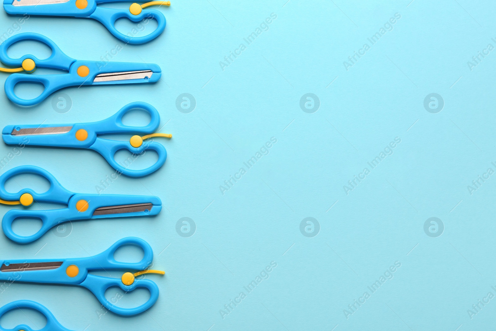 Photo of Set of training scissors on color background, flat lay. Space for text