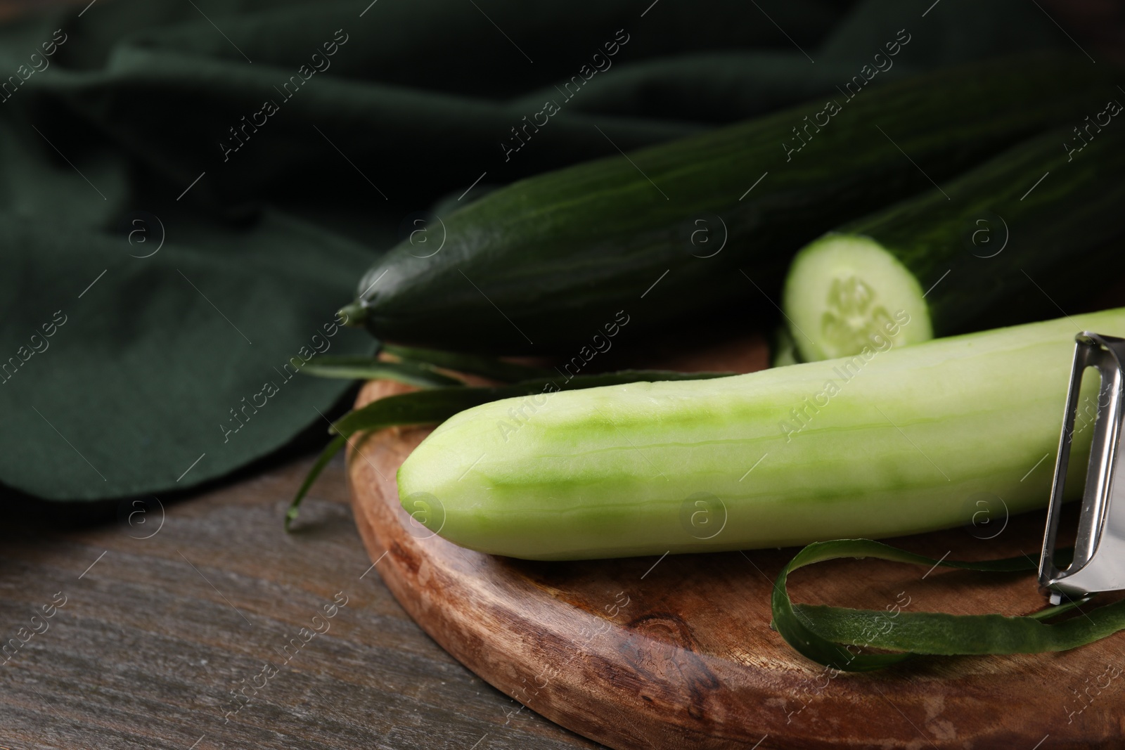 Photo of Fresh cucumbers on wooden table, closeup. Space for text