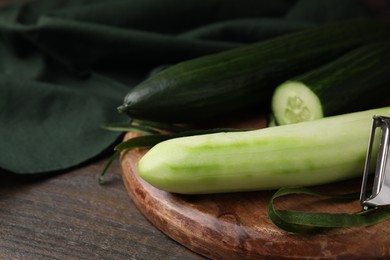 Fresh cucumbers on wooden table, closeup. Space for text