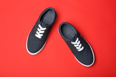 Photo of Stylish new shoes on color background, top view