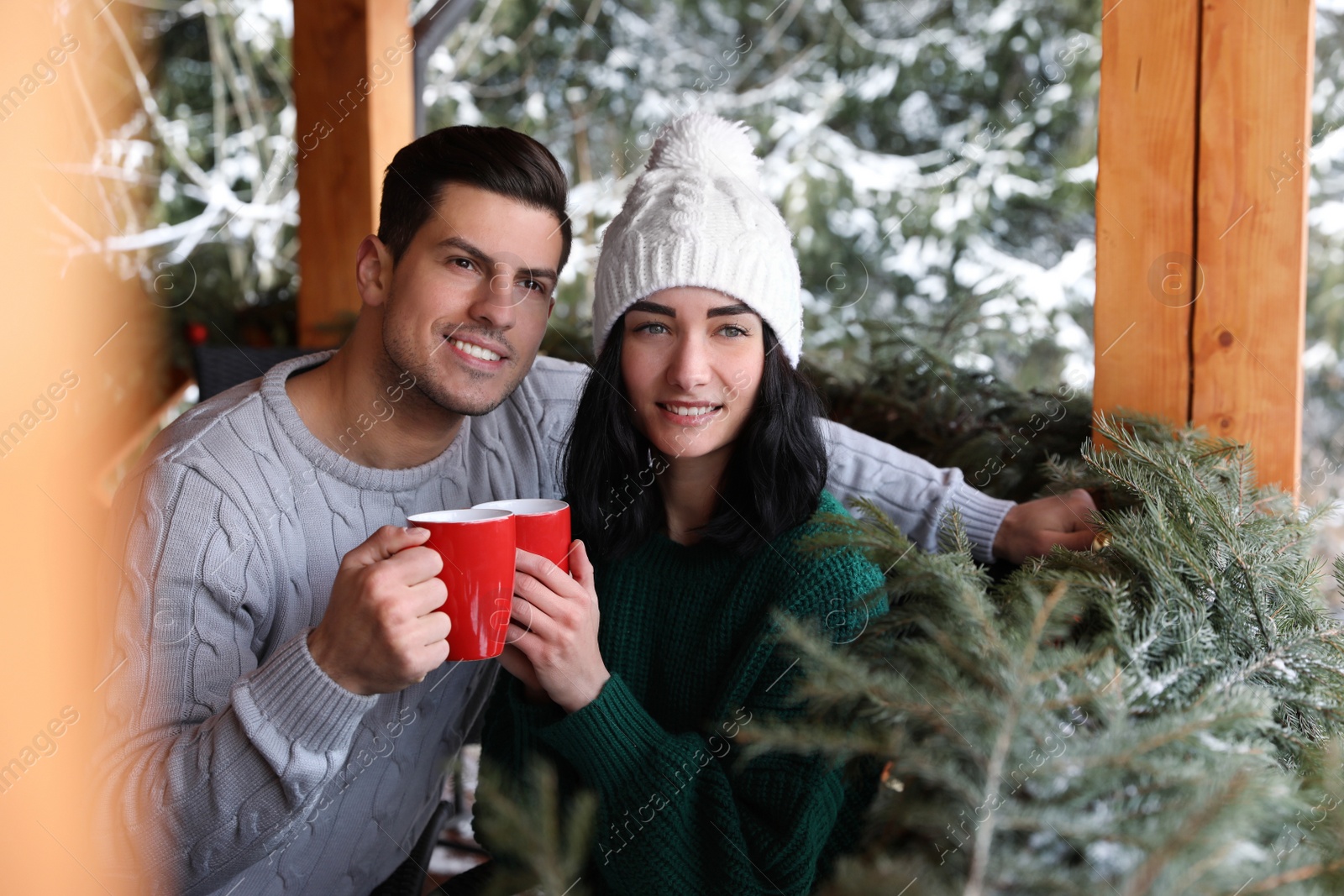 Photo of Happy couple in cafe near snowy forest. Winter vacation