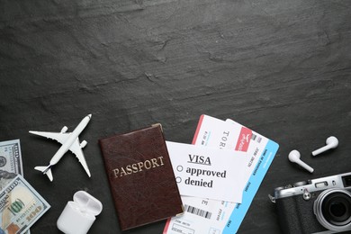 Flat lay composition with passport, toy plane and tickets on black table, space for text. Visa receiving