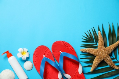 Photo of Flat lay composition with stylish beach accessories on light blue background, space for text