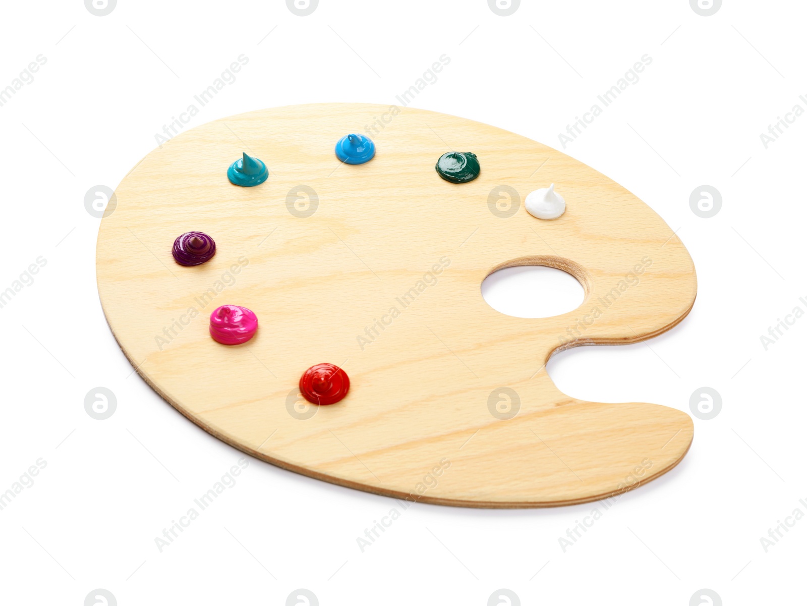 Photo of Wooden artist's palette with samples of paints isolated on white