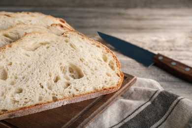 Photo of Freshly baked sodawater bread on wooden board, closeup