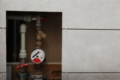 Photo of Water meter and ceramic tiles with spacers on wall