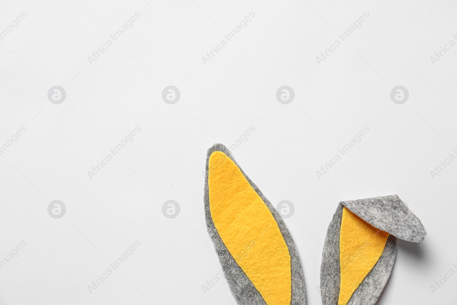 Photo of Funny Easter bunny ears on white background, top view