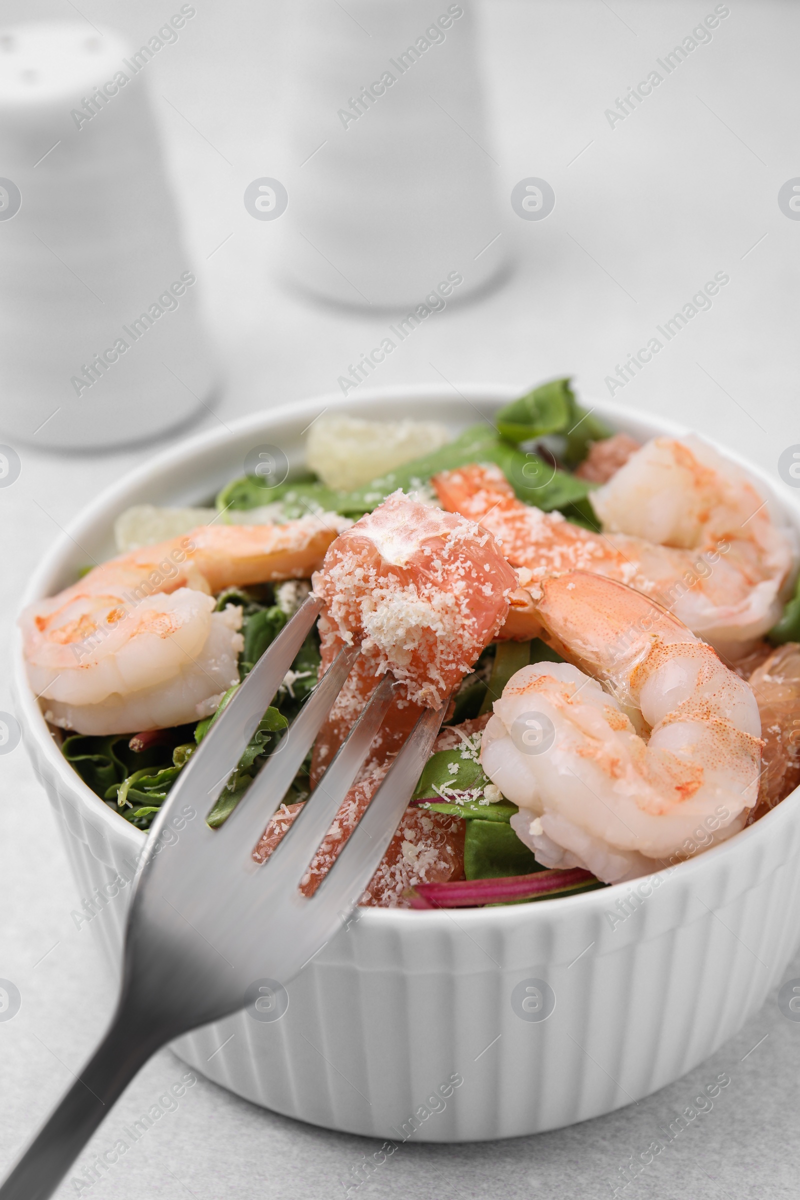 Photo of Delicious salad with pomelo, shrimps and tomatoes on white table, closeup