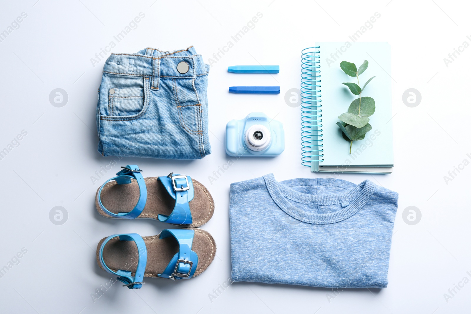 Photo of Flat lay composition with little photographer's toy camera on white background