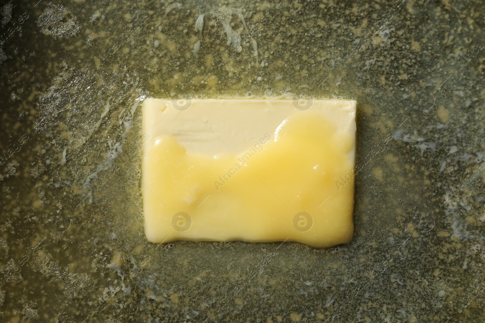 Photo of Tasty melting butter, top view. Dairy product