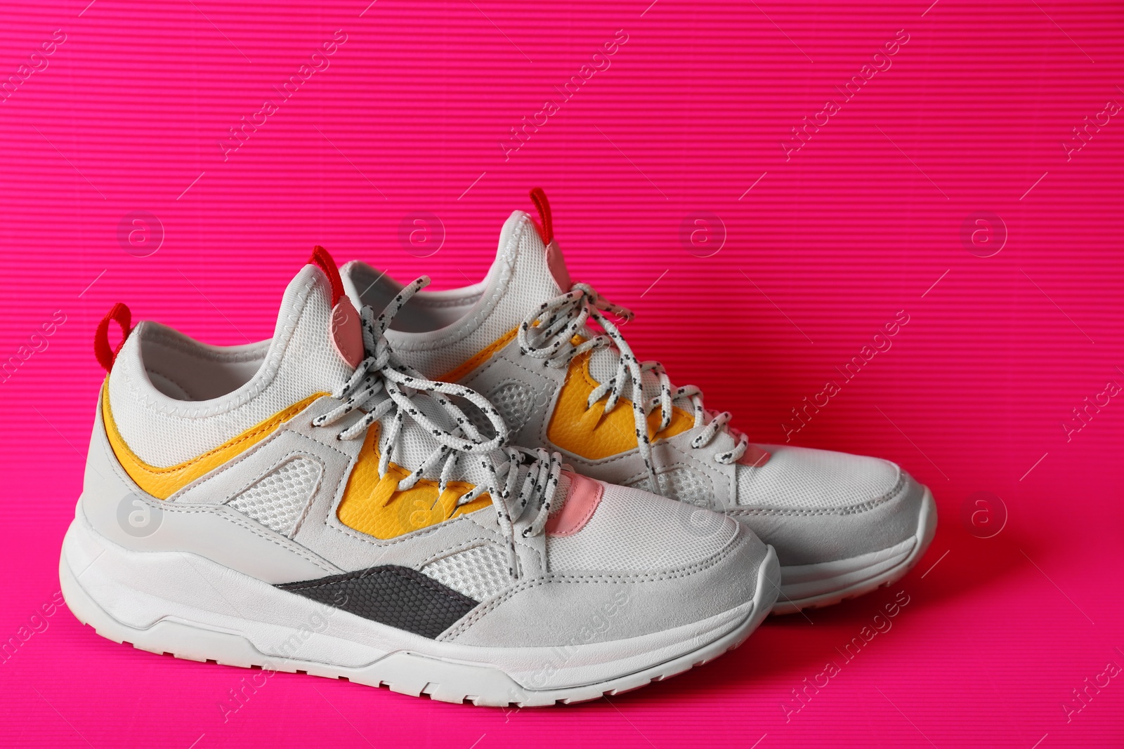 Photo of Pair of sneakers on color background. Healthy lifestyle