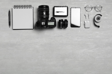 Flat lay composition with equipment for journalist on light table. Space for text