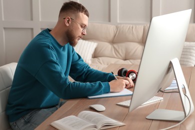 Online test. Man studying at desk indoors