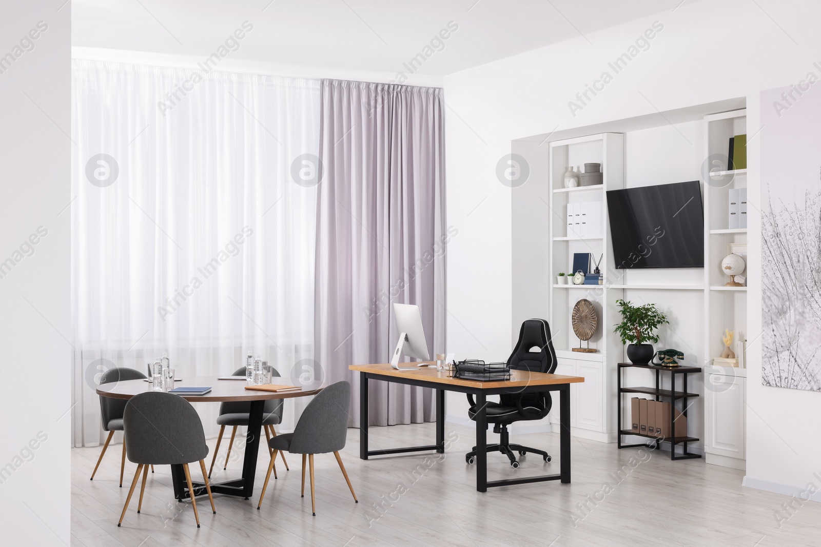 Photo of Stylish office with comfortable furniture and tv zone. Interior design