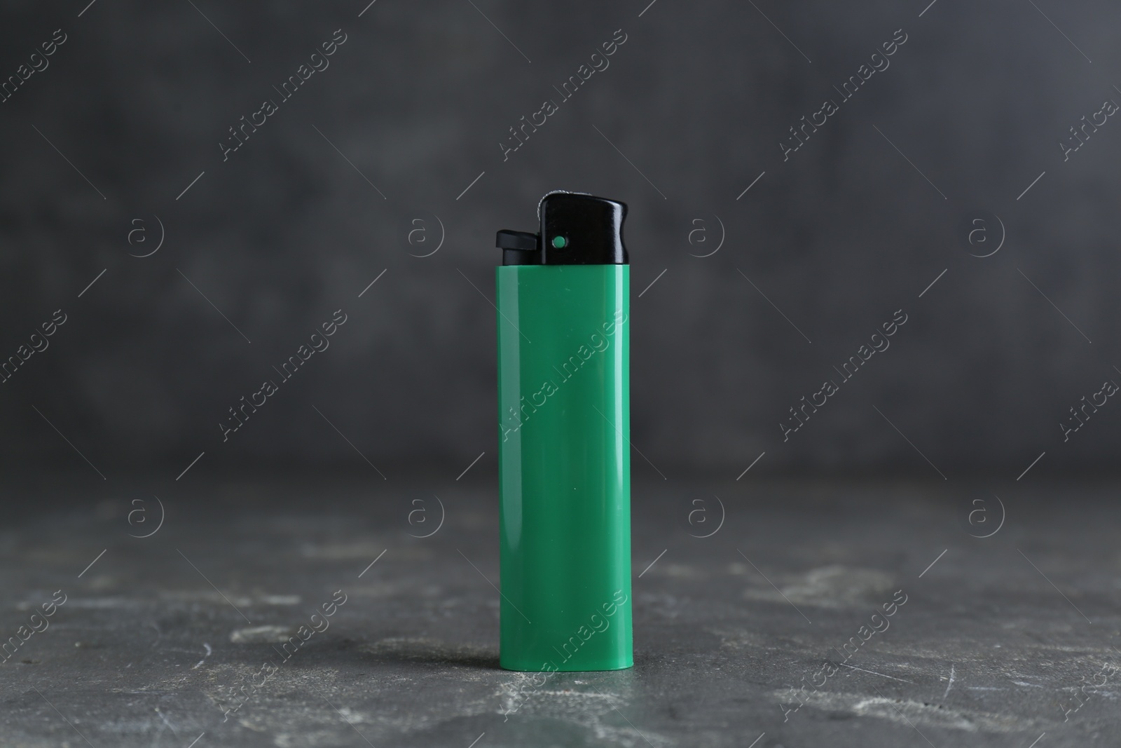 Photo of Stylish small pocket lighter on grey table