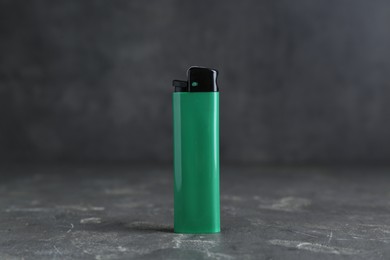 Photo of Stylish small pocket lighter on grey table