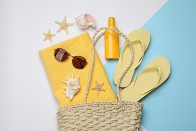 Stylish bag and beach accessories on color background, flat lay