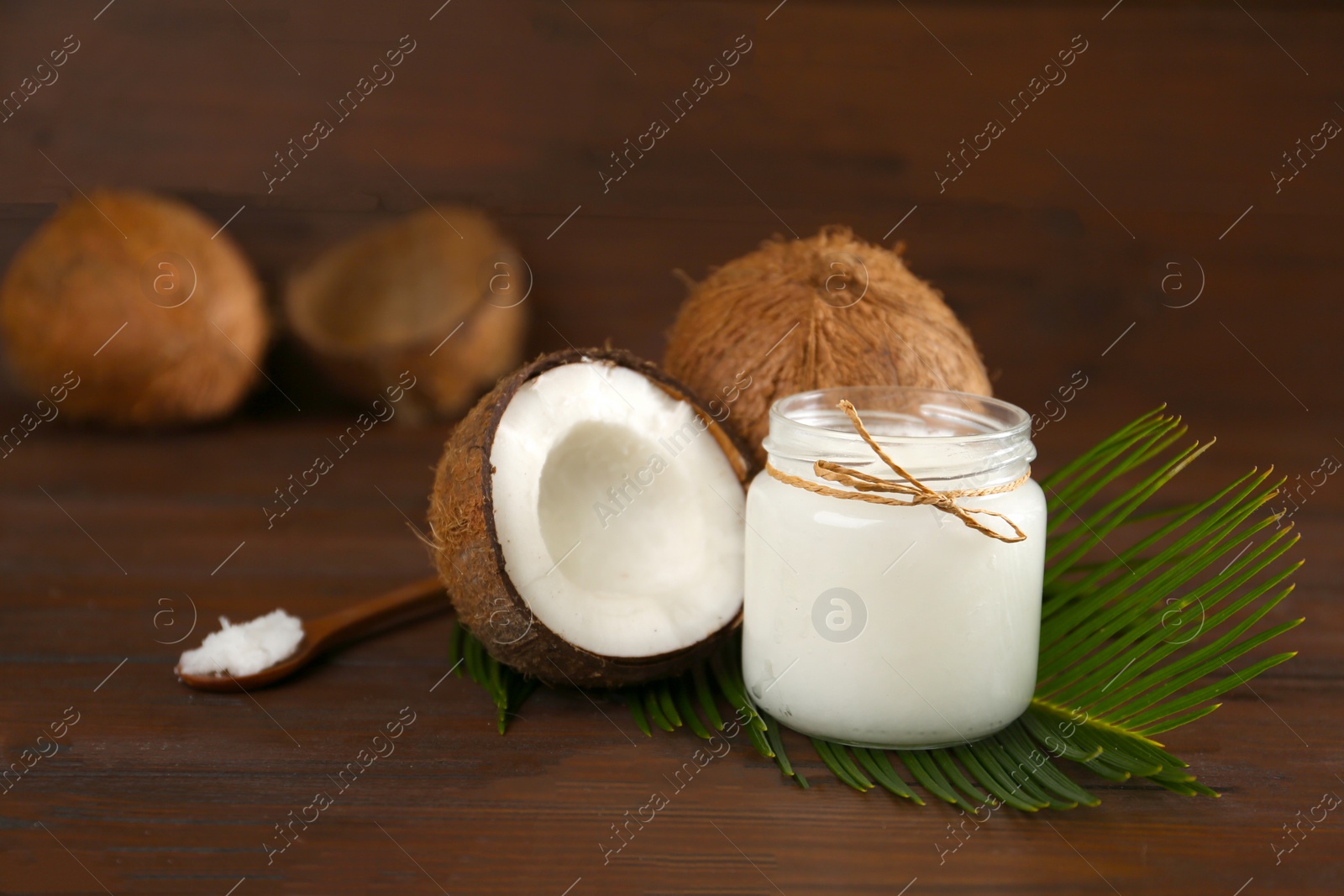 Photo of Composition with organic coconut oil on wooden table. Healthy cooking