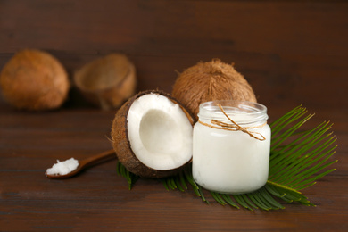 Photo of Composition with organic coconut oil on wooden table. Healthy cooking