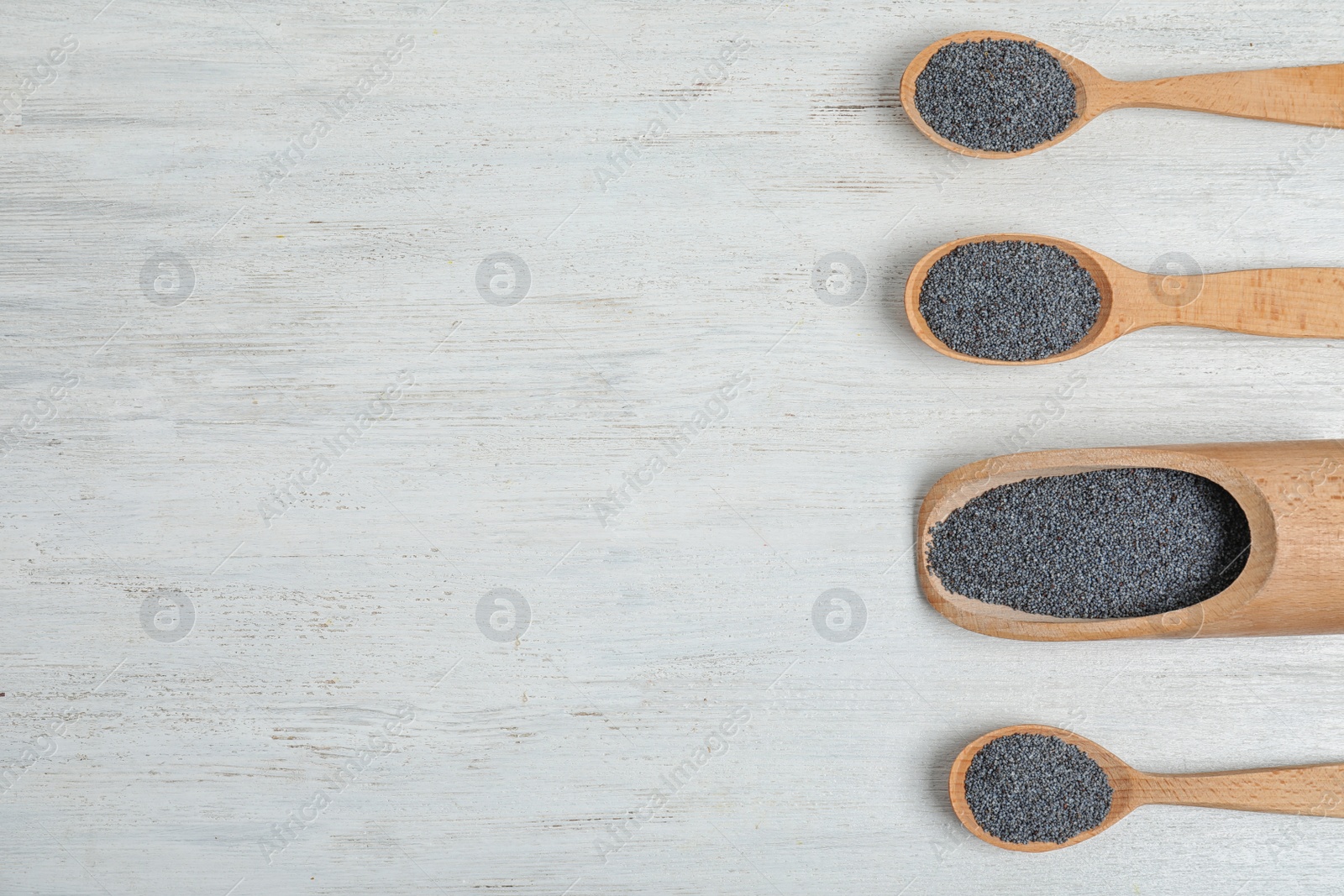 Photo of Flat lay composition with poppy seeds and space for text on white wooden background