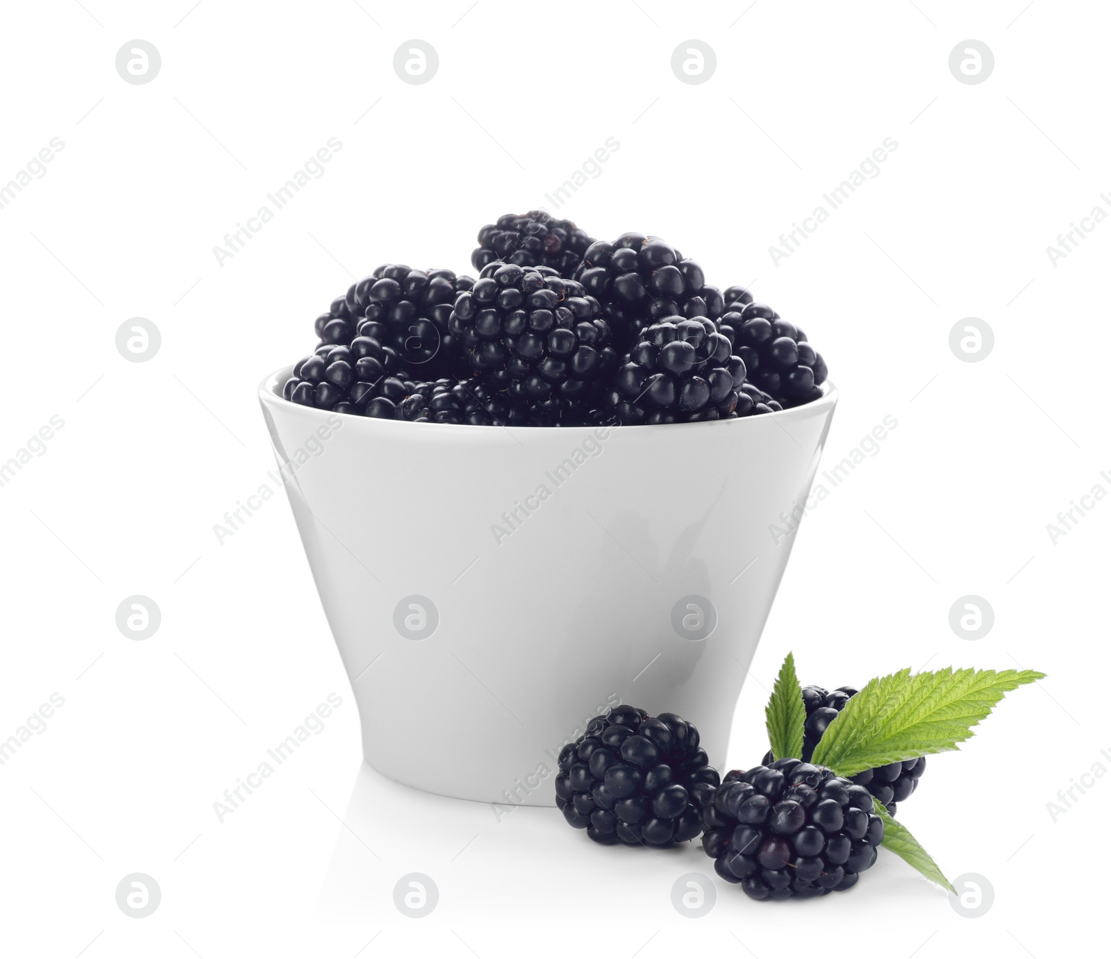 Photo of Bowl with ripe blackberries on white background