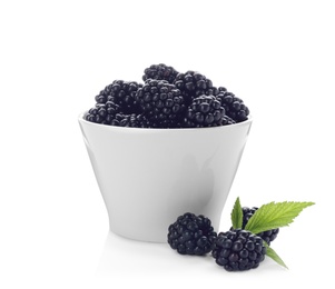 Bowl with ripe blackberries on white background