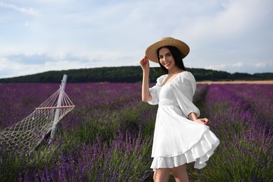 Beautiful young woman walking in lavender field