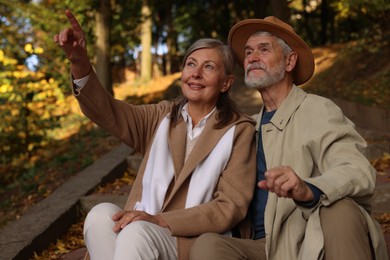 Photo of Affectionate senior couple spending time together in autumn park