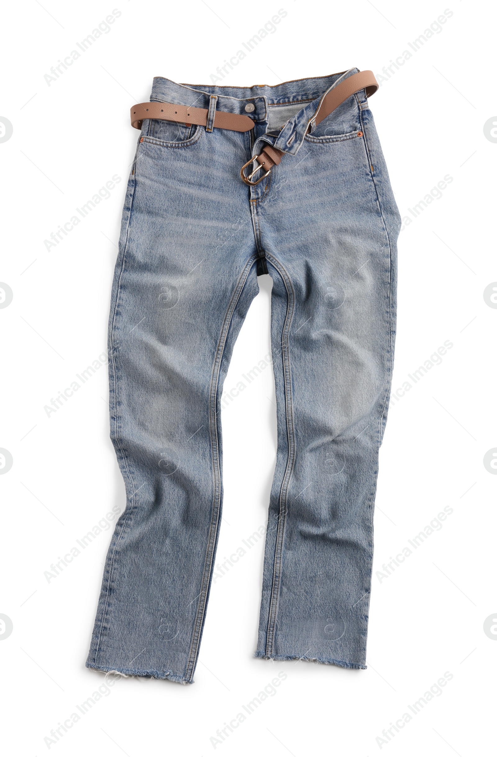 Photo of Rumpled light blue jeans with belt isolated on white, top view. Stylish clothes