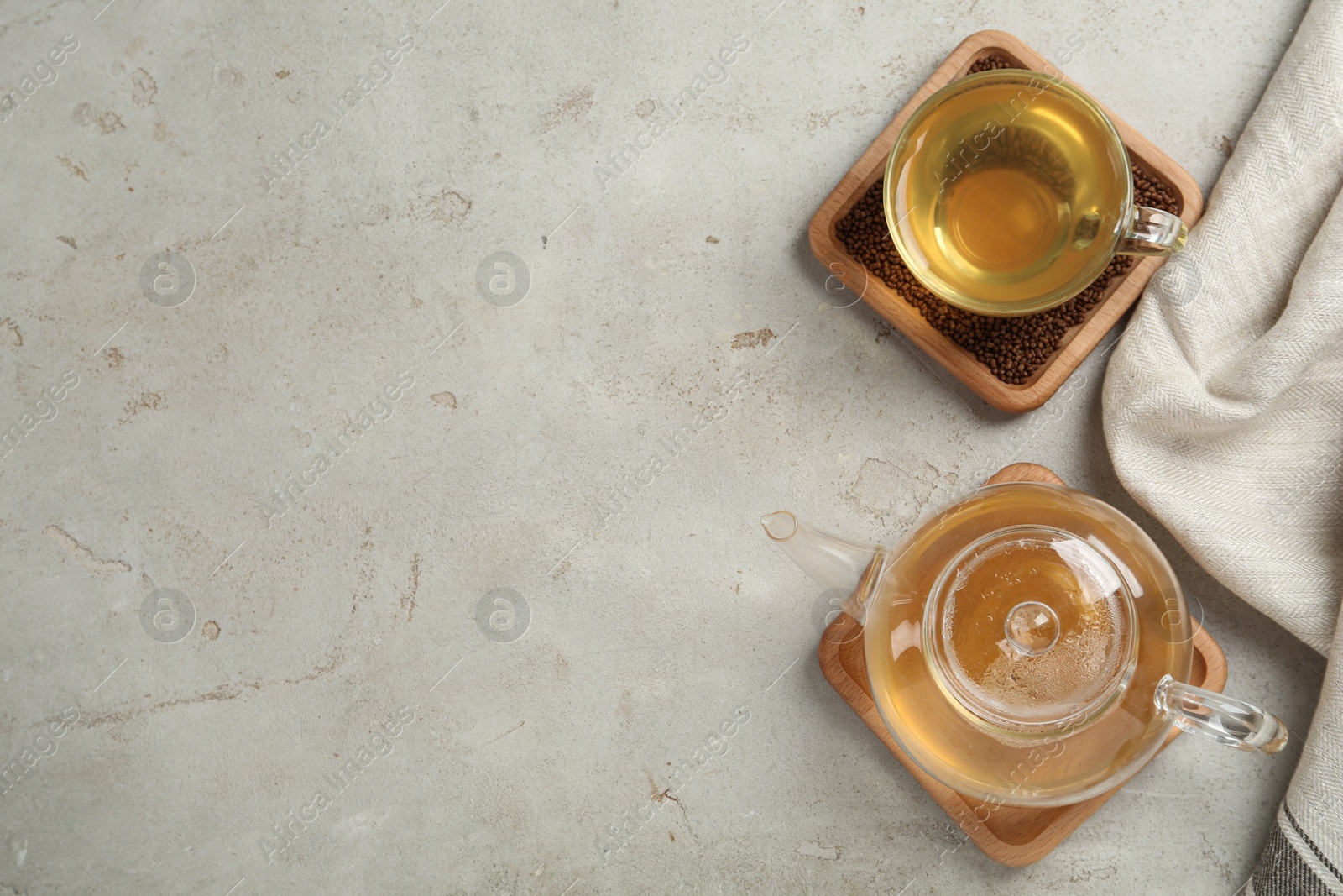 Photo of Buckwheat tea and granules on light table, flat lay. Space for text