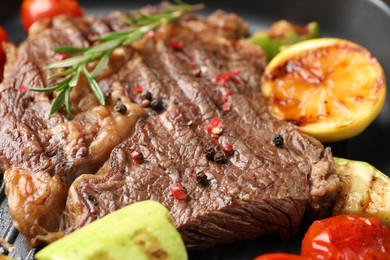 Delicious grilled beef steak and vegetables in frying pan, closeup