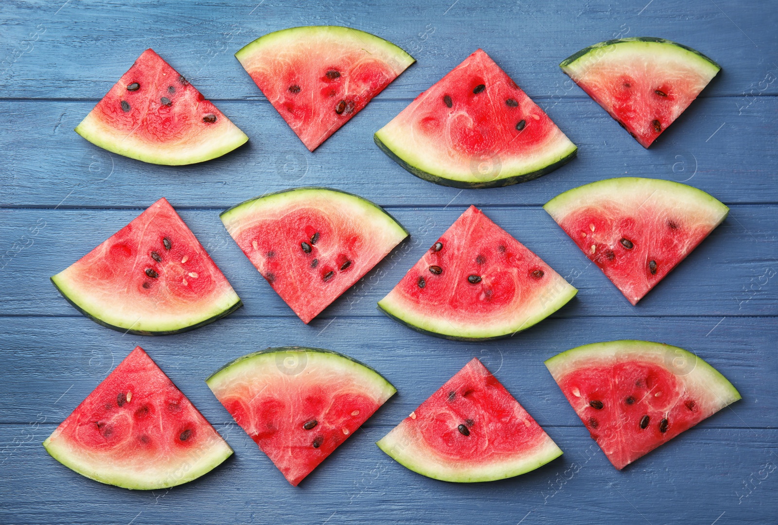 Photo of Flat lay composition with watermelon slices on wooden background