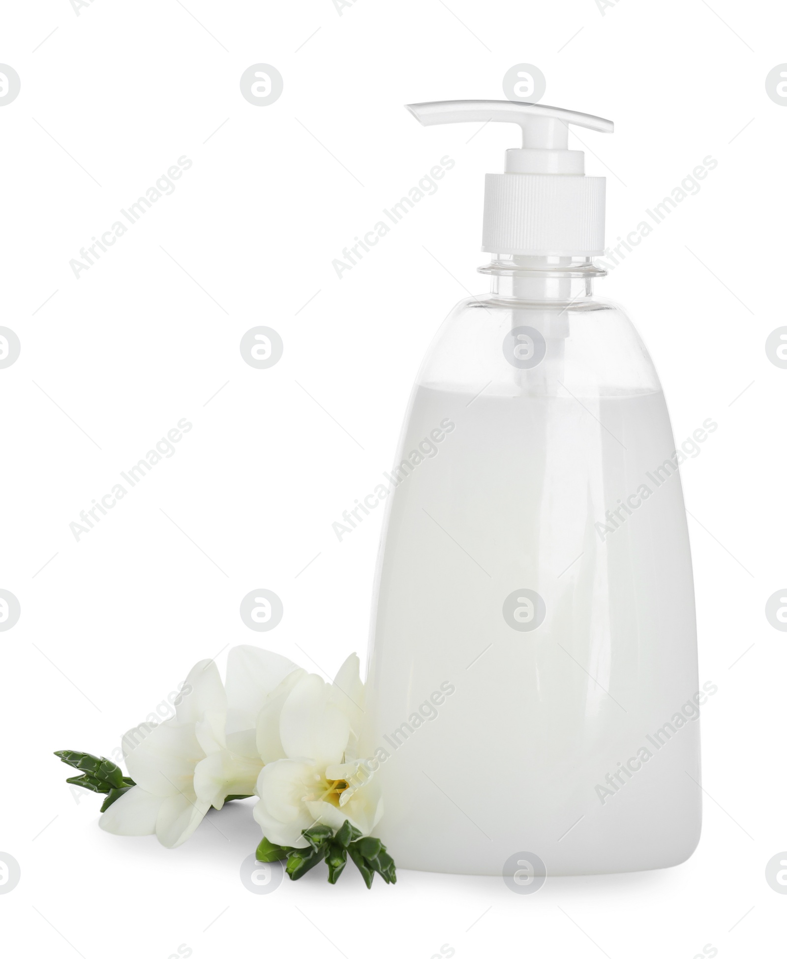 Photo of Dispenser with liquid soap and freesia flowers on white background