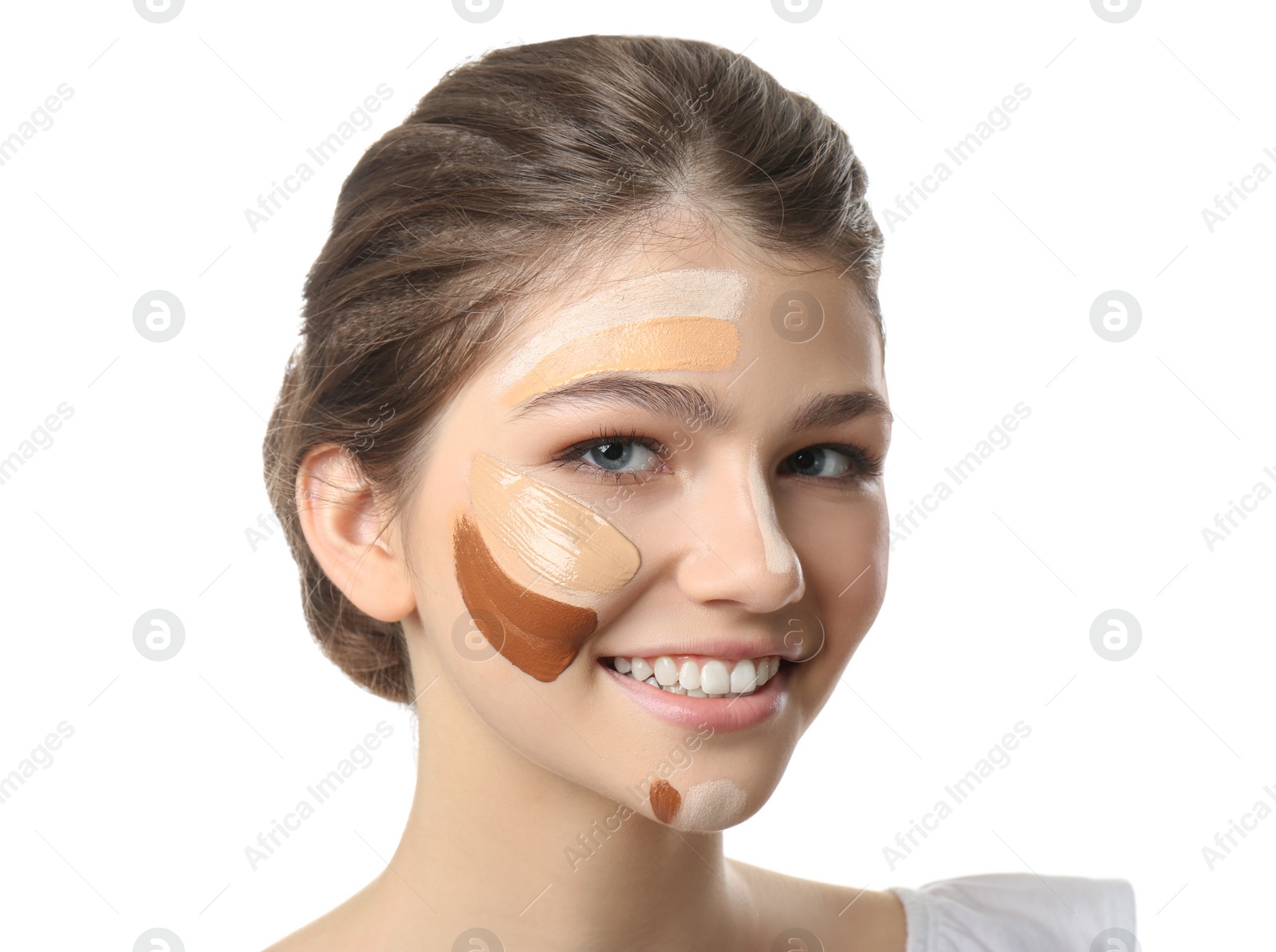 Photo of Beautiful girl on white background. Using concealer and foundation for face contouring