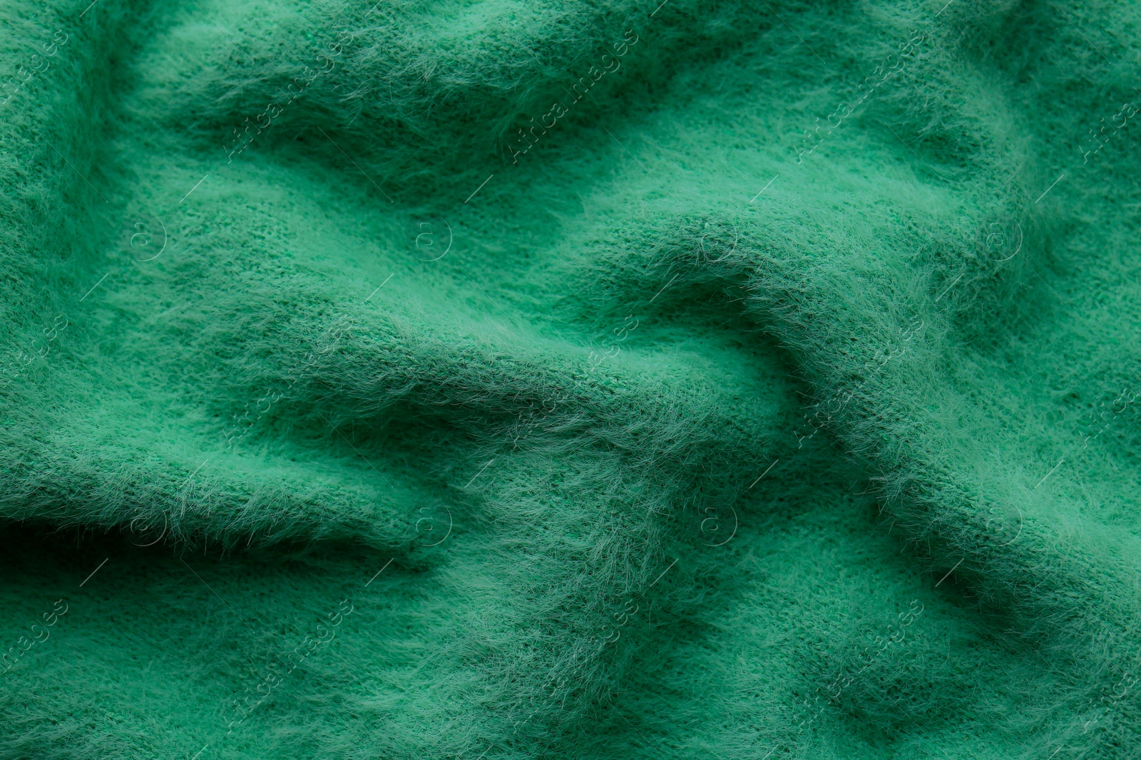 Photo of Beautiful green fabric as background, top view