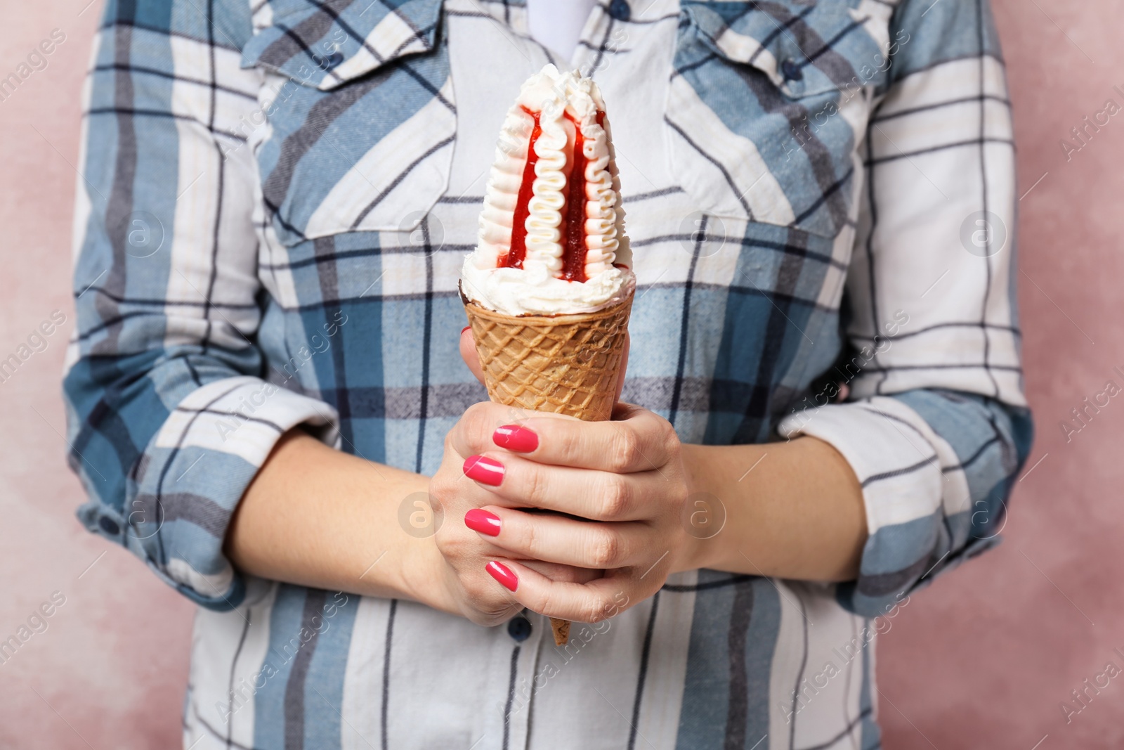 Photo of Woman holding yummy ice cream, closeup. Focus on hands