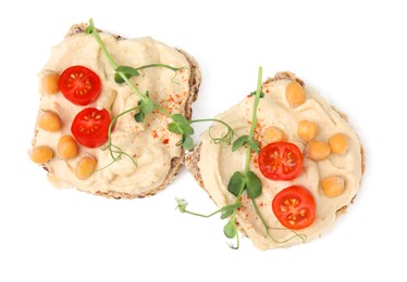 Photo of Delicious sandwiches with hummus, tomato slices and chickpeas on white background, top view