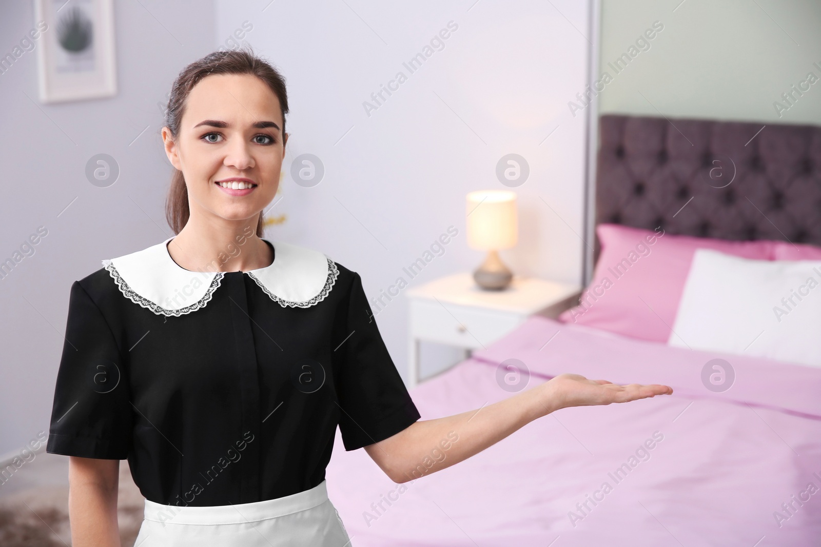 Photo of Young maid in hotel room