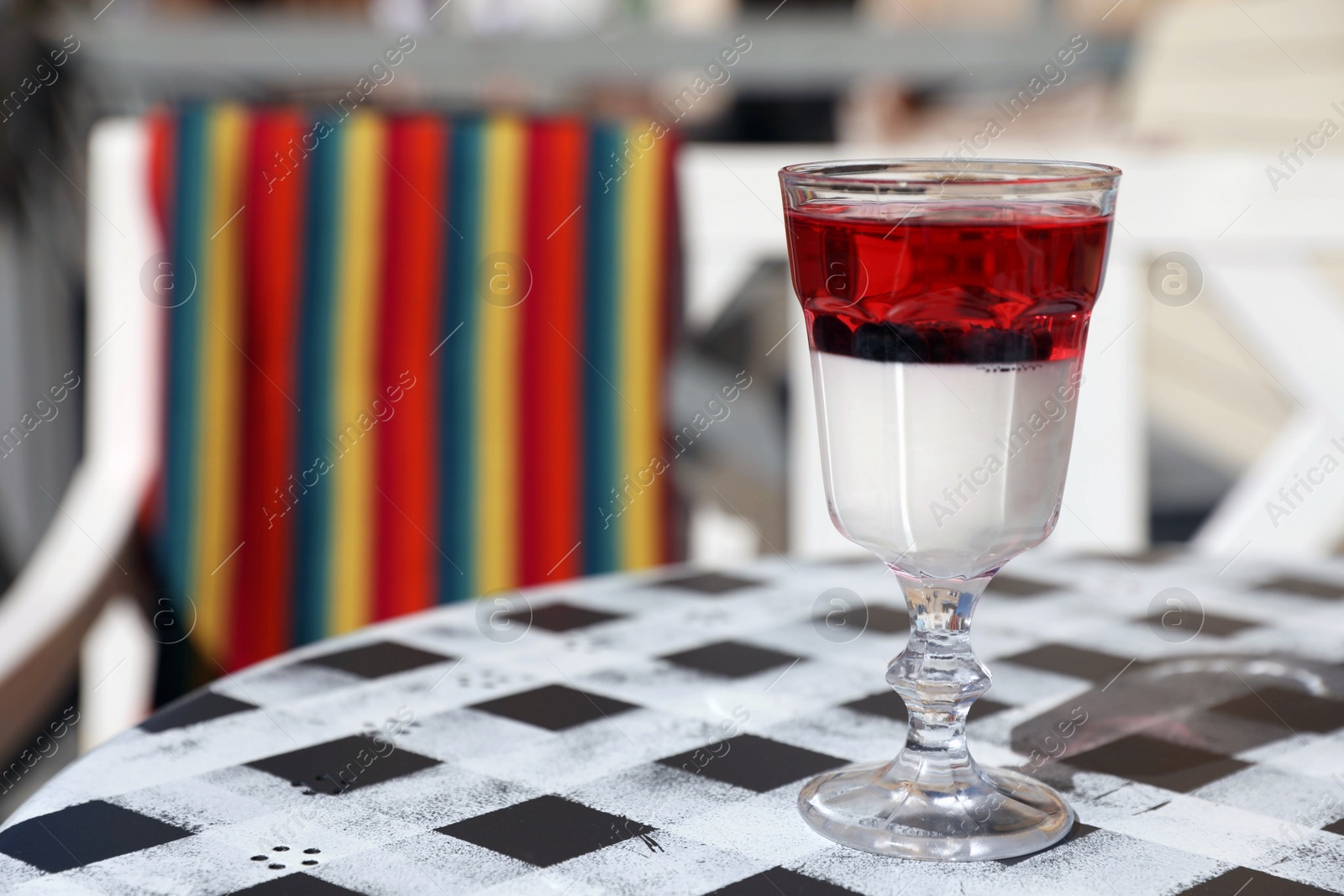 Photo of Delicious panna cotta dessert on table in cafe. Space for text