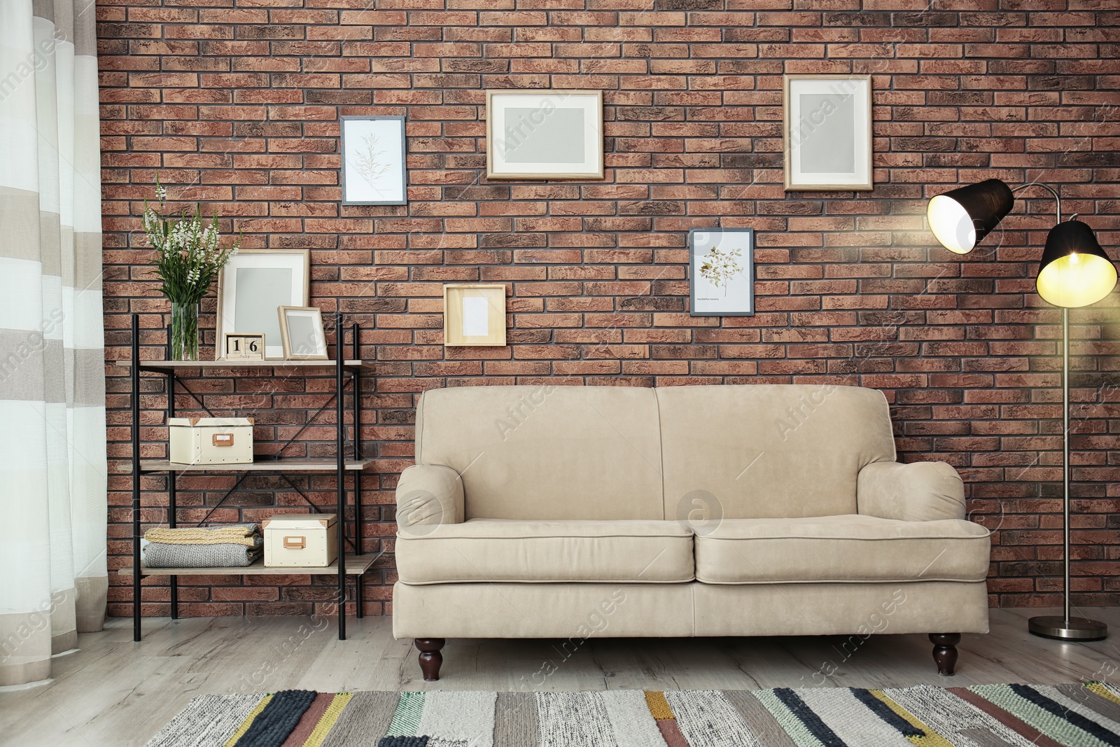 Photo of Modern living room interior with comfortable sofa near brick wall