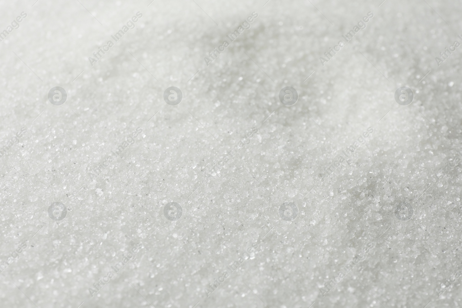Photo of White granulated sugar as background, closeup view