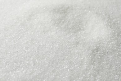 Photo of White granulated sugar as background, closeup view