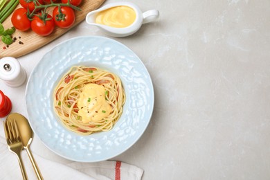 Photo of Delicious spaghetti with meat and cheese sauce served on light grey table, flat lay. Space for text