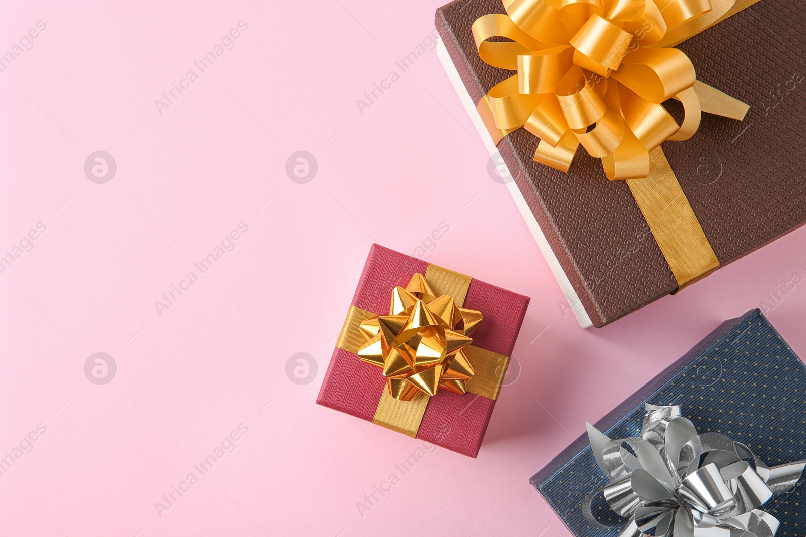 Photo of Flat lay composition with beautiful gift boxes on pink background. Space for text