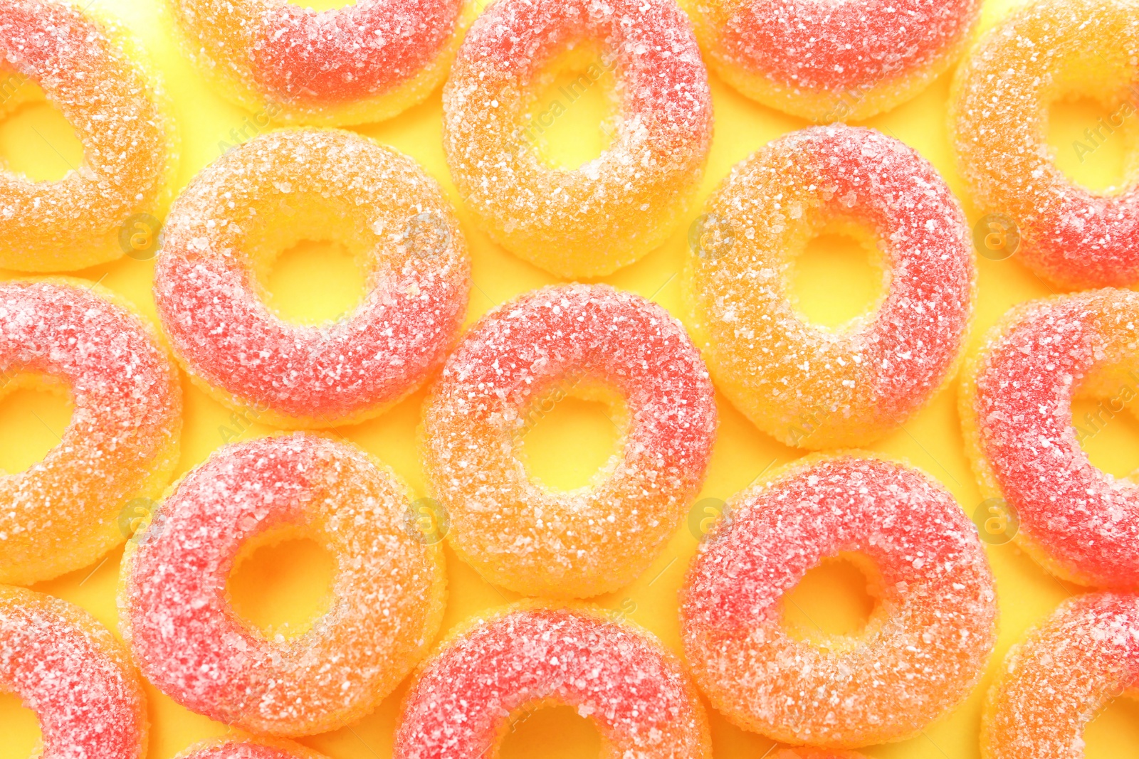 Photo of Tasty jelly candies on color background, top view